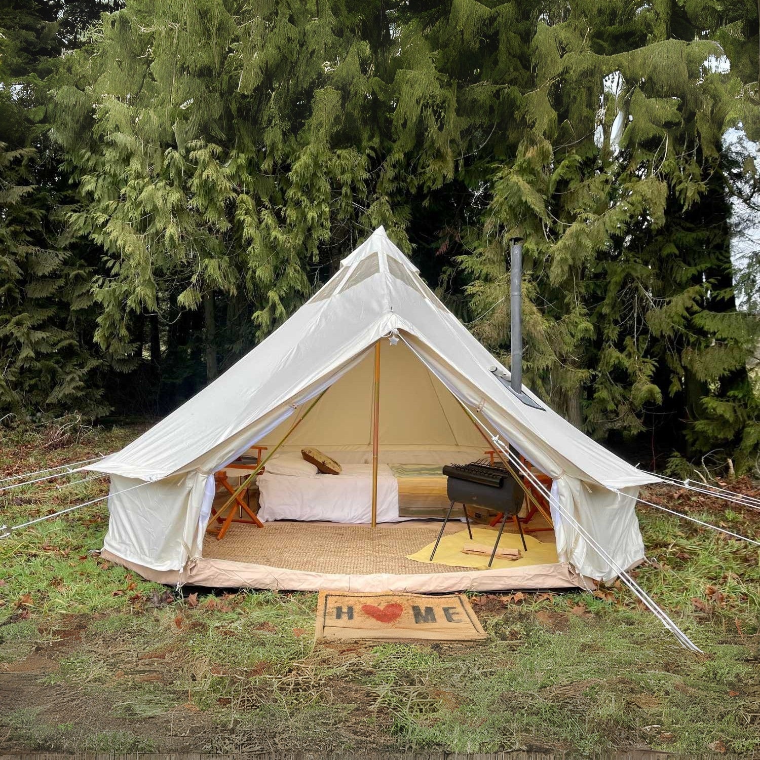 Yurt Tent Stella Stargazer by Life in Tents 13ft front view on grass near trees with home door mat