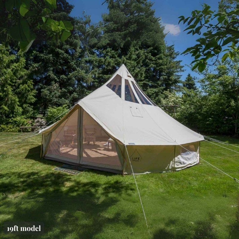 Yurt Tent Stella Stargazer by Life in Tents 19ft front left view on grass near trees