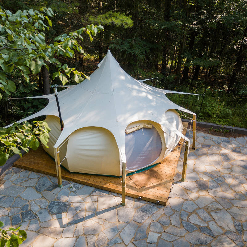 Yurt Tent Temple Apex by Canvas Camp birds eye view drone view on wood platform in forest